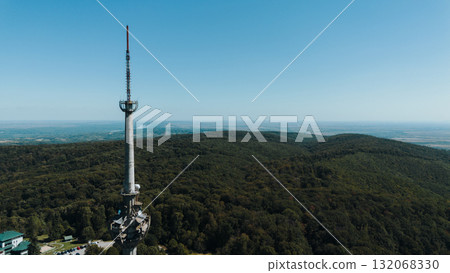Aerial view of TV tower Iriski Venac rising above the forested hills of Fruska Gora National Park with panoramic landscapes. Was damaged by a NATO missile during the Yugoslav War Aerial view of TV tower Iriski Venac rising above the forested hills of Fruska Gora National Park with panoramic landscapes. Was damaged by a NATO missile during the Yugoslav War 132068330