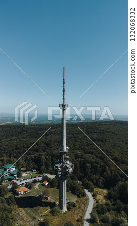 Aerial view of TV tower Iriski Venac rising above the forested hills of Fruska Gora National Park with panoramic landscapes. Was damaged by a NATO missile during the Yugoslav War Aerial view of TV tower Iriski Venac rising above the forested hills of Fruska Gora National Park with panoramic landscapes. Was damaged by a NATO missile during the Yugoslav War 132068332