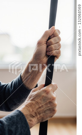 Senior Doing Gentle Resistance Exercise in Rehab Setting 132068569