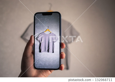 Woman photographs her old outfits for resale. Online resale platforms. Save planet and ecology concept. 132068711