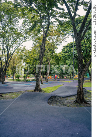 cushioned path for kids cycling or skating in park, soft track for children riding scooters or bikes and bicycle in safe playground area cushioned path for kids cycling or skating in park, soft track for children riding scooters or bikes and bicycle in safe playground area 132069186