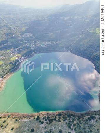 Scenic Lake Kournas in Crete on sunny day aerial view. Scenic Lake Kournas in Crete on sunny day aerial view. 132069491