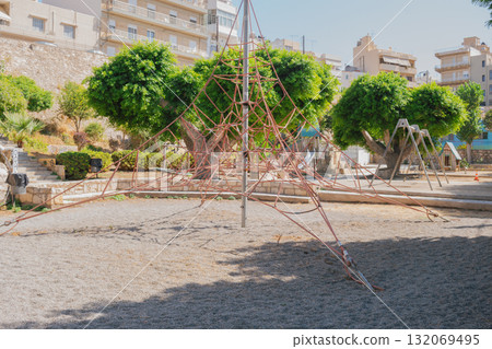 Playground climbing structure in city park shaped like pyramid. Playground climbing structure in city park shaped like pyramid. 132069495