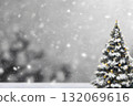 Christmas tree standing in falling snow. 132069616