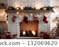 Christmas stockings hang on a fireplace with gifts below. 132069620