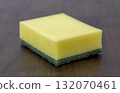 Yellow sponge green scrubber cleaning sponge kitchen sponge dish sponge household cleaning porous texture rectangular shape hygiene tool wood table surface 132070461