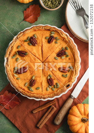 Pumpkin pie, Thanksgiving homemade crust tart, topped with pecan nuts and seeds Pumpkin pie, Thanksgiving homemade crust tart, topped with pecan nuts and seeds 132072138