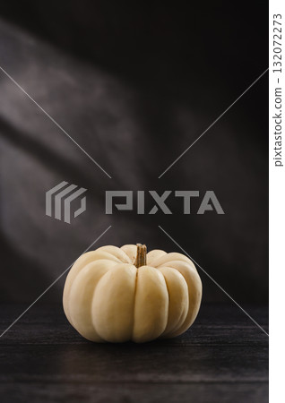 Whole white pumpkin on dark background, abstract autumn, concept, copy space Whole white pumpkin on dark background, abstract autumn, concept, copy space 132072273