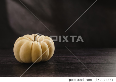 Whole white pumpkin on dark background, abstract autumn, concept, copy space Whole white pumpkin on dark background, abstract autumn, concept, copy space 132072274