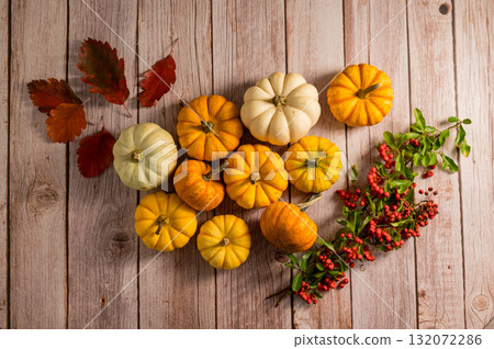 Autumn pumpkins frame background. Orange and white mini squashes, rustic style. Top view Autumn pumpkins frame background. Orange and white mini squashes, rustic style. Top view 132072286