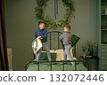 Boys are fighting with pillows on their parents' bed in the bedroom early on Christmas morning. 132072446