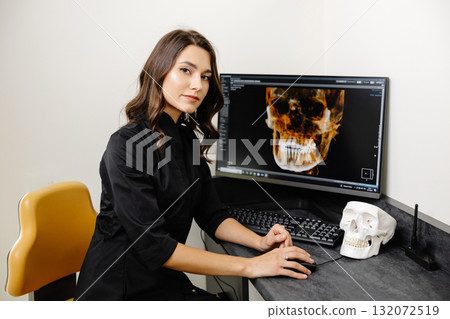 The dentist shows the patient his x-ray of the jaw. Panoramic shot of teeth on the screen at the dentist 132072519