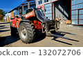 Telehandler parked near an industrial building during daylight in a construction area 132072706