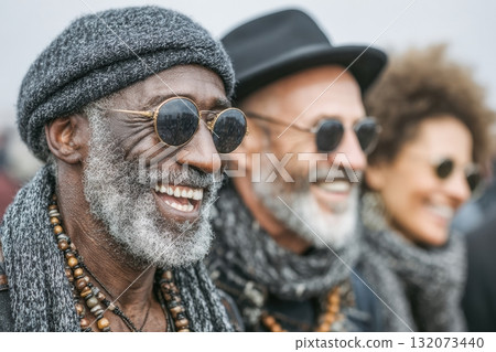Group of smiling individuals wearing sunglasses and stylish winter attire 132073440