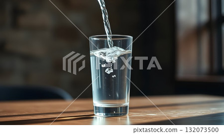 Clear glass of fresh water on a table. 132073500