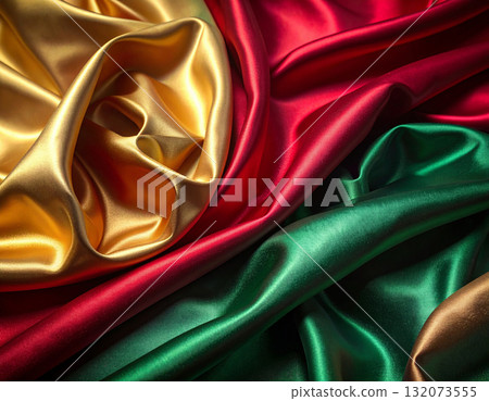 Luxurious satin fabric with a red, green and gold shine 132073555