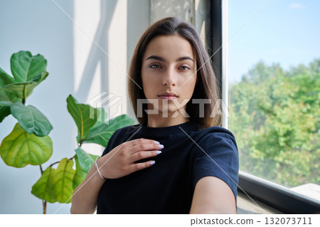 Close-up selfie portrait of teenage female looking at web camera Close-up selfie portrait of teenage female looking at web camera 132073711