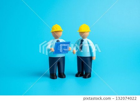 Builders study blueprints. Design and construction. Planning of new projects, teamwork of engineers and architects. Real estate development, technical supervision. Architecture, business 132074022