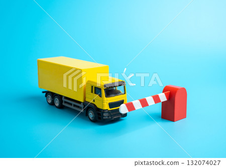 A truck is blocked from entering by a barrier. Border closure and trade restriction. Import and transit bans, economic blockade, and logistics disruption. Economics, trade, and geopolitics 132074027