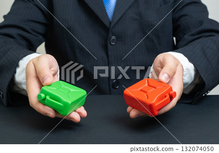 A businessman offers a choice between fossil and green fuels. Energy transition and environmental technologies. Ecology, renewable energy, and sustainability industry discussions. 132074050