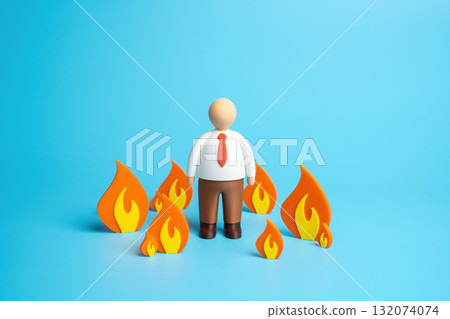 An office worker stands in the fire. A metaphor for looming deadlines, heavy workloads, and overtime. Burnout, pressure, and emotional exhaustion. Workplace stress and motivation 132074074