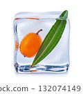Frozen fruit and leaf captured in clear ice cube showcasing freshness and creativity in food presentation 132074149
