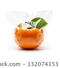 Fresh persimmon wrapped in clear plastic showcasing its bright orange color and green leaf detail 132074153