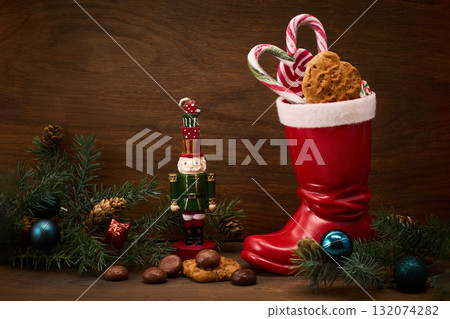 St. Nicholas Day. Red boot with sweets, spicy ginger cookies and gifts for December 6th St. Nicholas Day. Red boot with sweets, spicy ginger cookies and gifts for December 6th 132074282