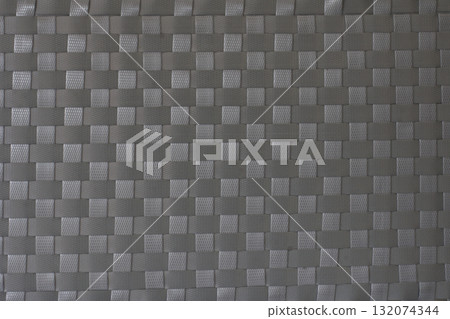 Handmade weave pattern of gray plastic strips texture for mats, baskets or rattan furniture. 132074344