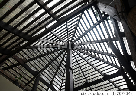 Roof structure of a modern building Made of wood and covered with transparent tile bringing natural light into the building 132074345
