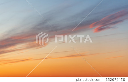 A tranquil sunset fills the sky with warm orange hues near the horizon A tranquil sunset fills the sky with warm orange hues near the horizon 132074458
