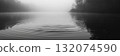 Calm river landscape with mist and reflection in autumn morning light 132074590