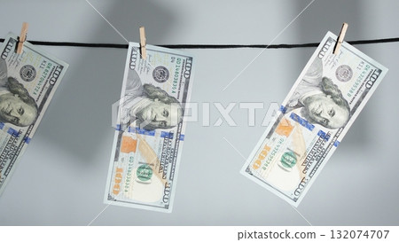 Currency Laundering Concept Freshly Printed Bills Drying on a Clothesline, Crime Metaphor 132074707