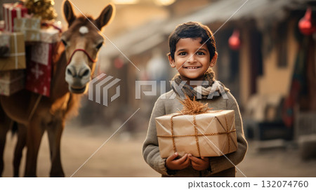 Indian kid with big giftbox is looking to the camera dusty street on background. Christmas support. Give and share kindness. 132074760