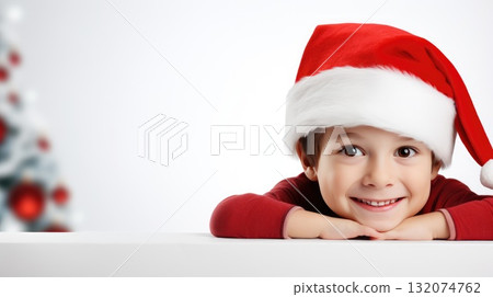 Surprised child in Santa hat hiding behind white advertisement board, Copy space for text or design, kid peeking out blank banner. Surprised child in Santa hat hiding behind white advertisement board, Copy space for text or design, kid peeking out blank banner. 132074762