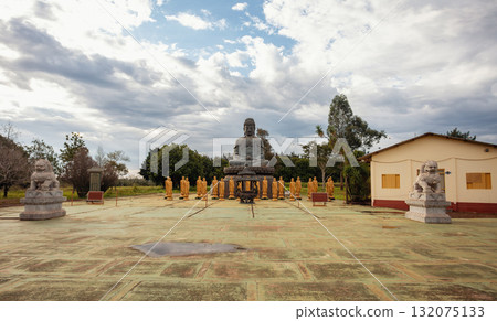 Buddha statue surrounded by golden figures, guarded by Foo Lions, at the Chen Tien Buddhist Temple in Foz do Iguacu, Brazil. Buddha statue surrounded by golden figures, guarded by Foo Lions, at the Chen Tien Buddhist Temple in Foz do Iguacu, Brazil. 132075133