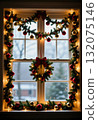 A beautifully decorated window features green garlands, red ornaments, and sparkling lights, creating a warm holiday atmosphere in a home Generative AI 132075146