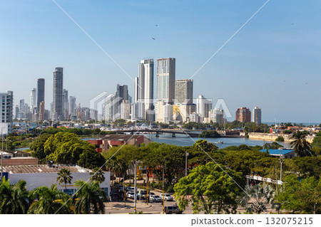 Panoramic view of the modern skyline of Cartagena de Indias, Colombia, featuring high-rise buildings against a clear blue sky. Panoramic view of the modern skyline of Cartagena de Indias, Colombia, featuring high-rise buildings against a clear blue sky. 132075215
