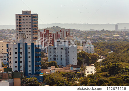 Dense urban landscape of Cartagena de Indias, Colombia, showing residential high-rise buildings surrounded by tropical vegetation. Dense urban landscape of Cartagena de Indias, Colombia, showing residential high-rise buildings surrounded by tropical vegetation. 132075216