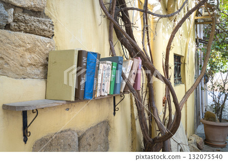 a shelf with old books on the outside wall of a house in Buku, Azerbaijan 132075540