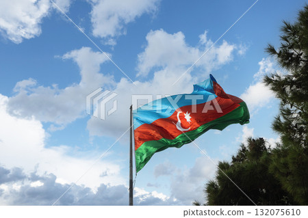 the Azerbaijani flag flying on the flagpole inBaku, Azerbaijan 132075610