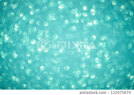 Defocused lights from turquoise glitter as a background. Defocused lights from turquoise glitter as a background. 132075674