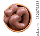 Gingerbread, dipped in milk chocolate, in wooden bowl. Heart and star shaped German Lebkuchen, traditional spicy gingerbread, fluffy and soft like cake, coated with milk chocolate. Isolated over white 132075838