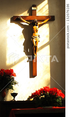 Wooden cross with a statue of Jesus Christ on top of it 132076186
