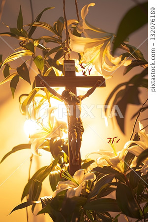 Crucifix is hanging from a plant, with the sun shining on it 132076189