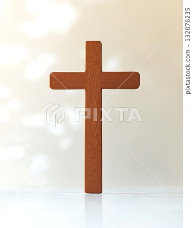 Wooden cross is standing on a white background 132076235