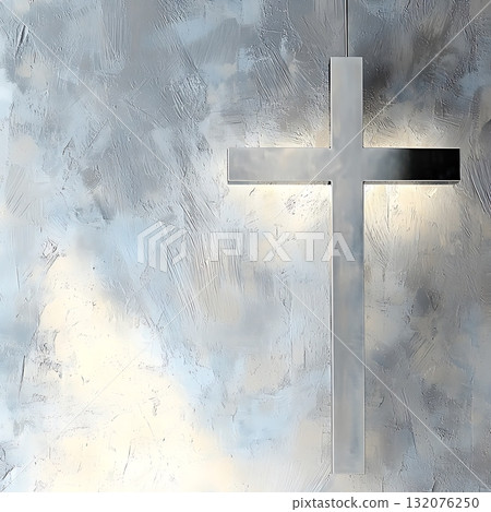 Silver cross is hanging from a wall with a grey background 132076250