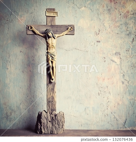 Wooden cross with Jesus Christ on it is standing on a rock 132076436