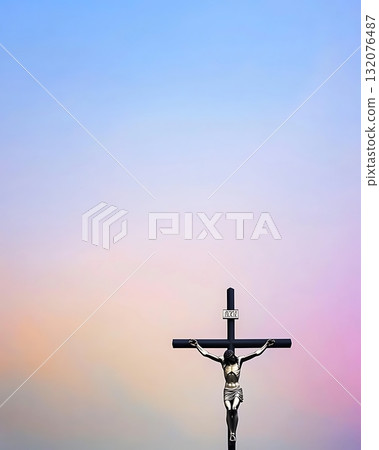 Cross with the word Jesus on it is standing in front of a blue sky 132076487