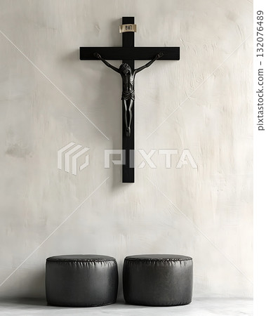 Crucifix is hanging on a wall next to two black leather chairs Crucifix is hanging on a wall next to two black leather chairs 132076489